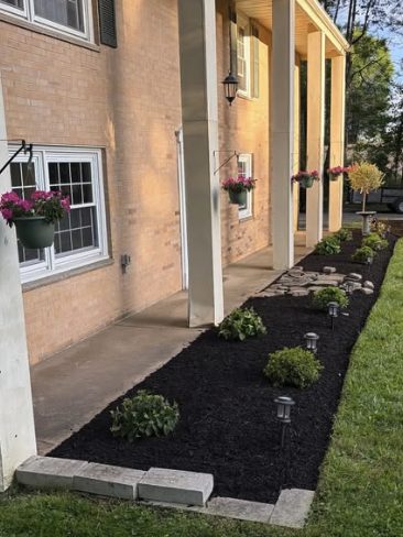 Finished mulch bed with landscape lighting by Samscaped